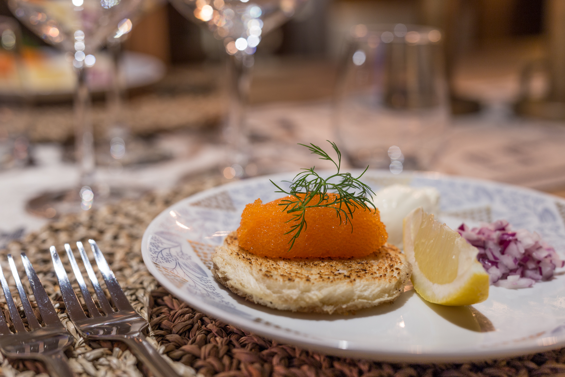 Elegantly plated Nordic starter with vendace roe, dill, lemon and red onion